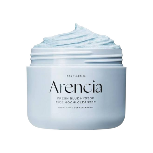 KYRÁ Arencia Hyssop brightening face scrub and cleanser in a light blue jar with a unique mochi-like texture.